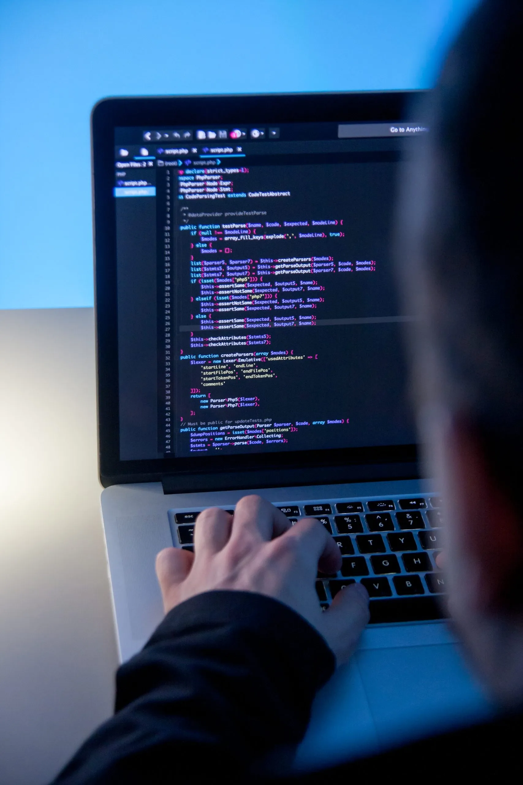 Programmer working on laptop in office